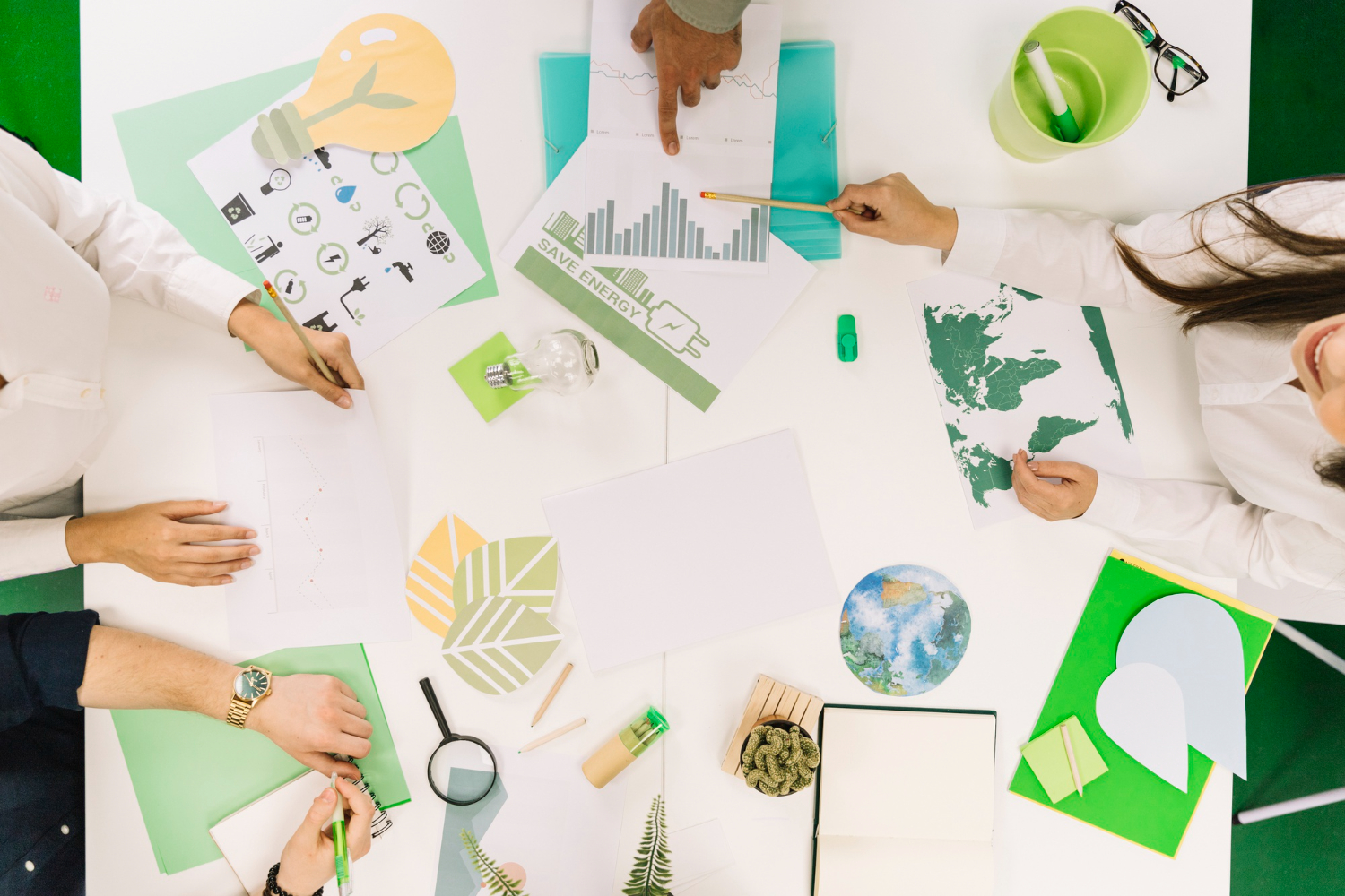 businesspeople-working-graph-with-various-natural-resources-icon-desk